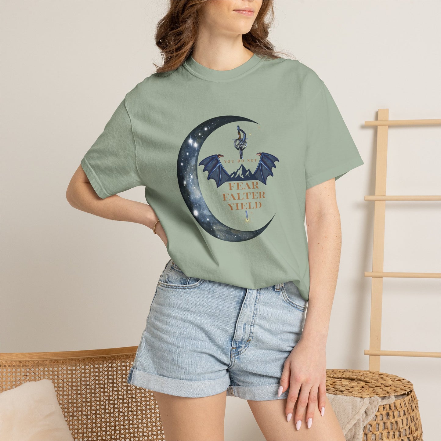 Person wearing a green t-shirt with a graphic design and text, standing against a neutral background.