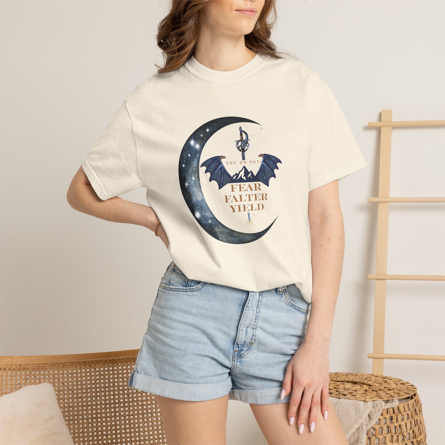 Person wearing a white t-shirt with a graphic design and text, standing against a neutral background.