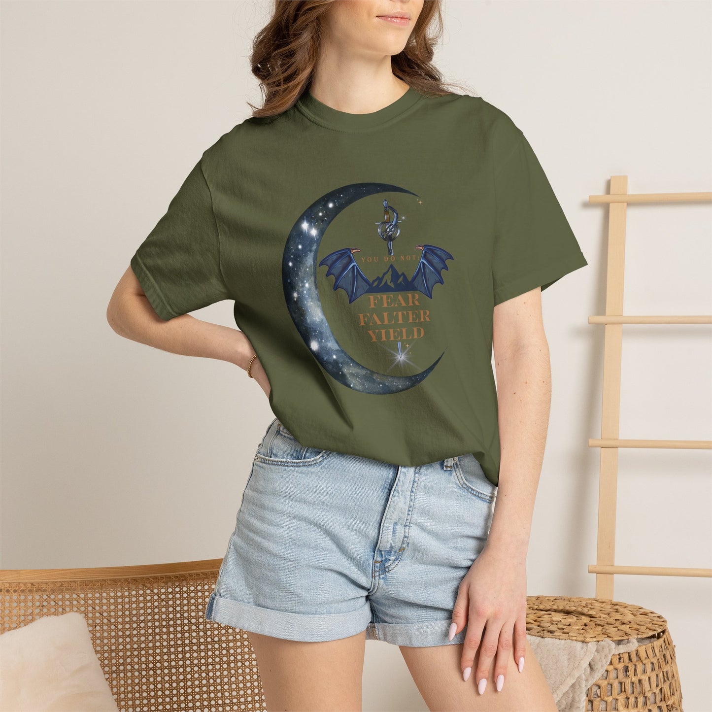 Person wearing a green t-shirt with a graphic design and text, standing against a neutral background.