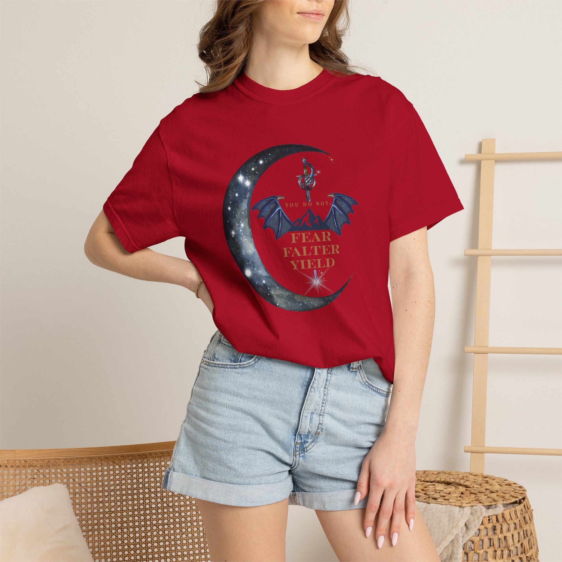 Person wearing a red t-shirt with a graphic design and text, standing against a neutral background.