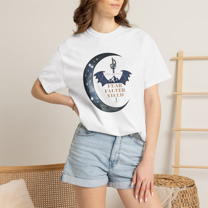 Person wearing a white t-shirt with a graphic design and denim shorts in a casual setting.