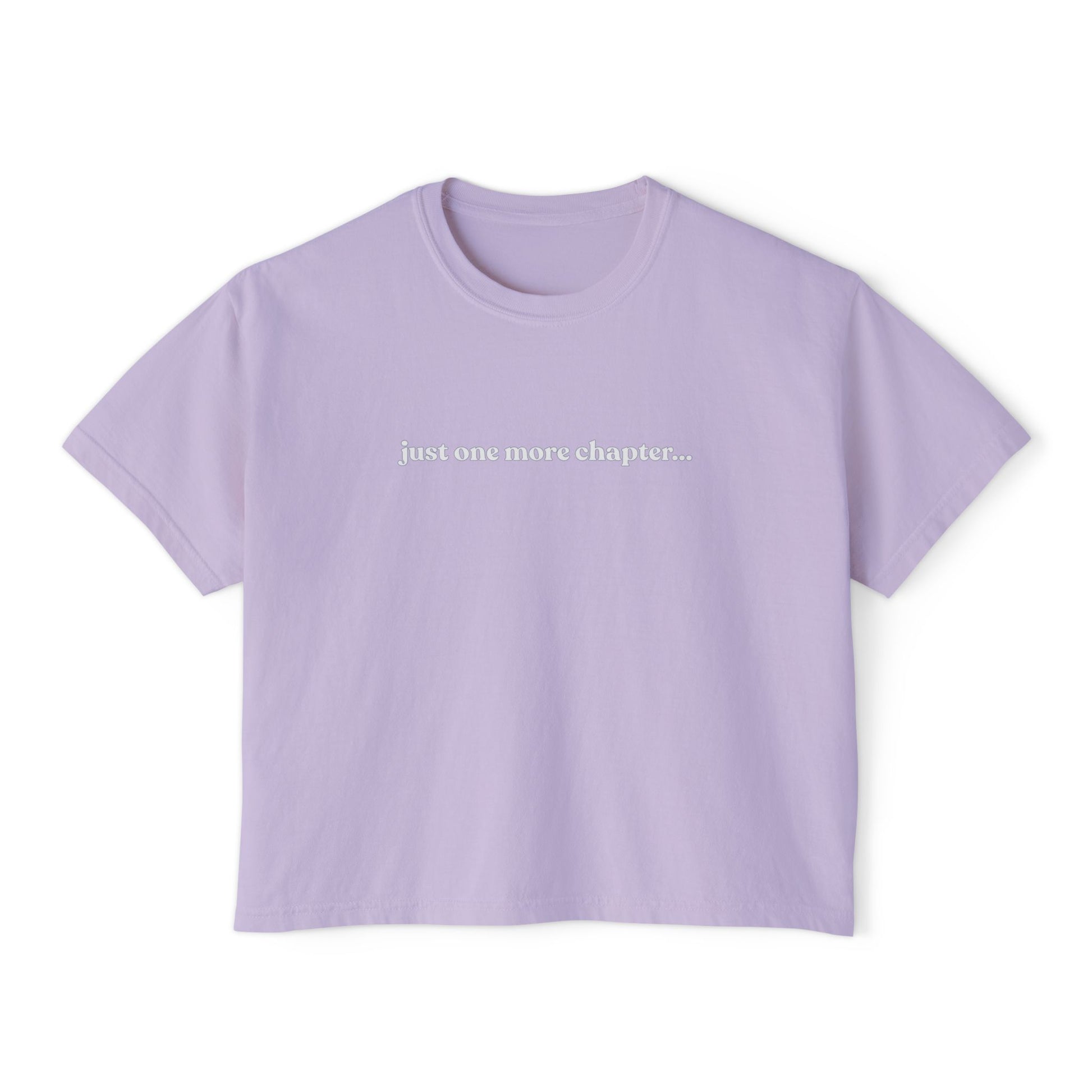 Lavender t-shirt with text 'just one more chapter...' on a white background