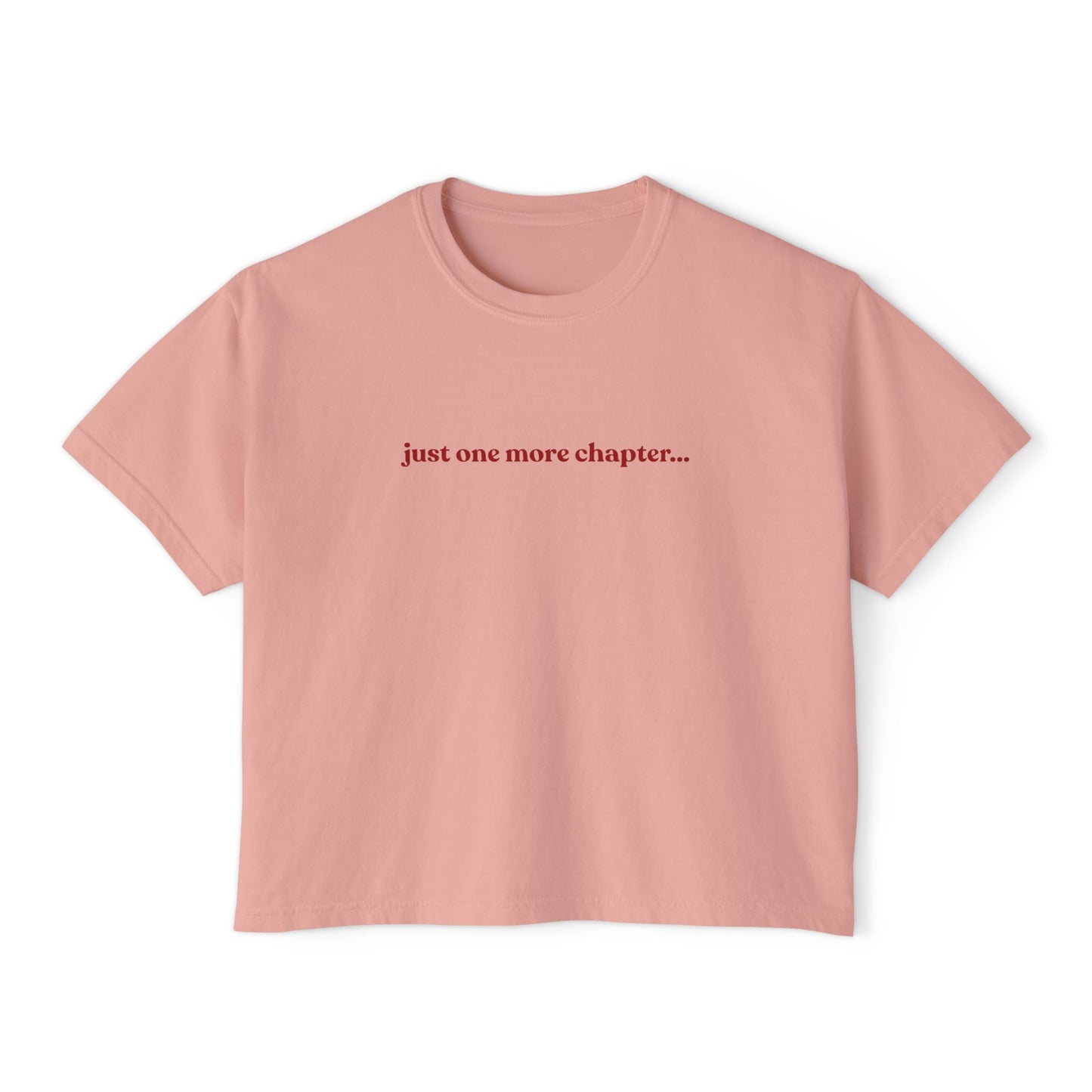 Pink t-shirt with 'just one more chapter...' text on a white background
